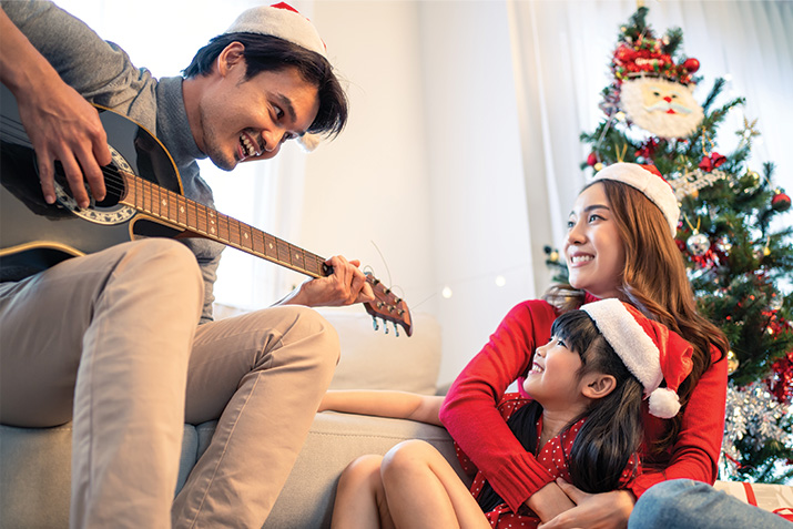 family music, Christmas music, playing Christmas songs, a dad playing his guitar for his family and playing a classic song