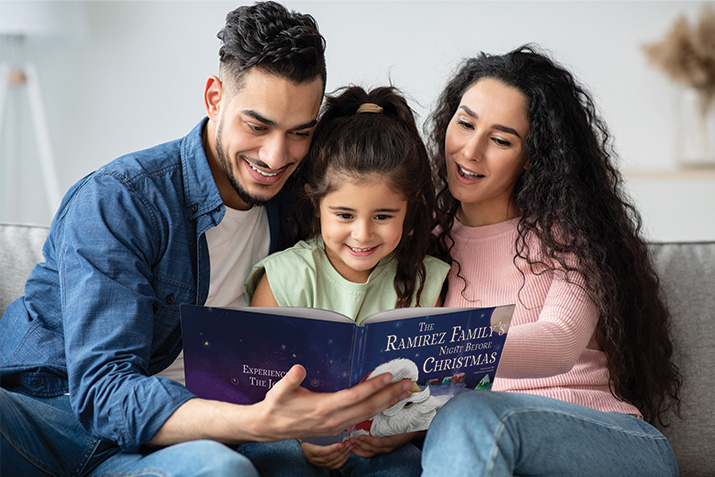 Family reading Our Family's Night Before Christmas personalized book. 